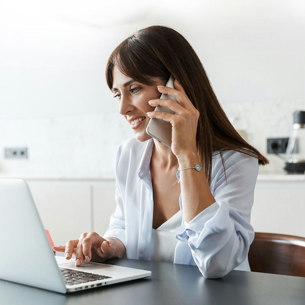 woman on computer making a phone call
